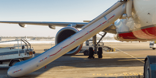 Emergency evacuation slide deployed from a commercial airplane on the airport tarmac.