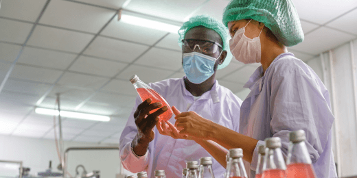 Two workers complying with ppe in manufacturing