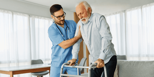 A caregiver helping an elderly person stand up.