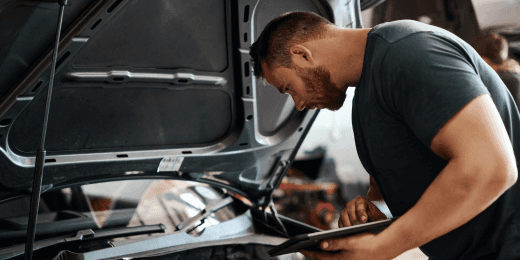 an inspector using a car fluids checklist