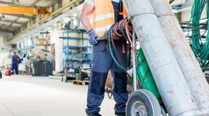 a professional transporting a gas cylinder according to the safety guidelines outlined in a gas cylinder safety checklist|Gas Cylinder Safety Checklist Sample Report|Gas Cylinder Safety Checklist