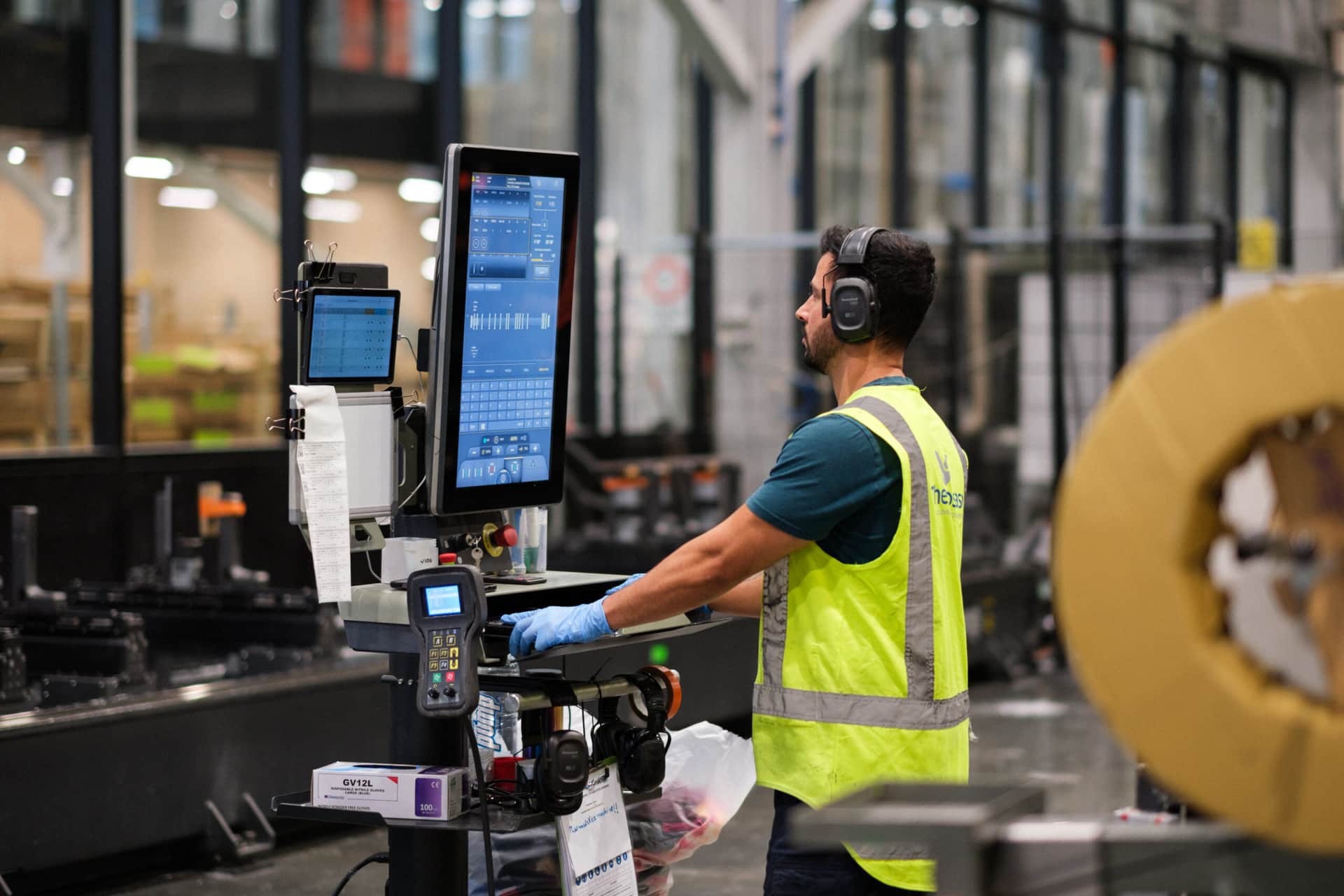 Thermosash Group manufacturing worker creating panels for bespoke building envelope | Image included in SafetyCulture manufacturing, construction, and installation case study