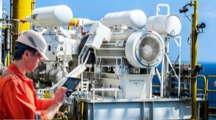 worker conducting air compressor checks