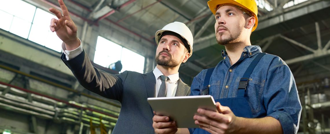 two safety professionals conducting a self-audit on workplace safety in accordance with OSHA standards