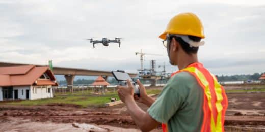 a safety professional operating a drone using a mobile device as part of the organization's overall AI in emergency management strategy