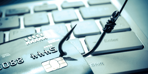 Credit card caught on a fishhook, symbolizing a phishing scam.