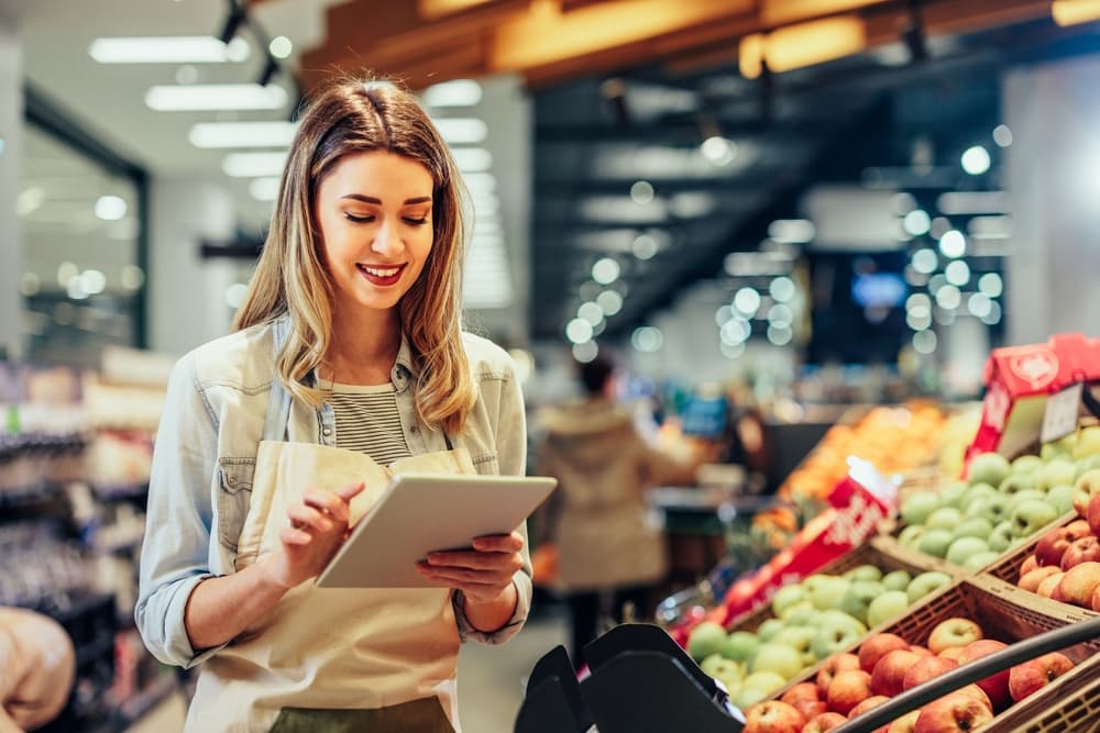 A shopkeeper performing inspections using retail customer experience software