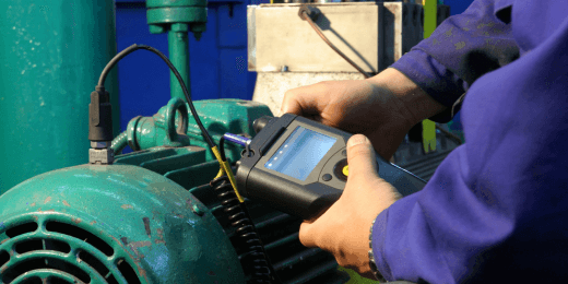 A technician analyzing the vibration of an industrial electric motor, to check up on issues or imbalances.