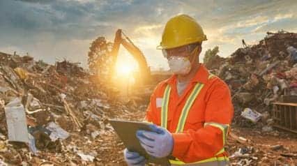 worker managing hazardous waste in landfills