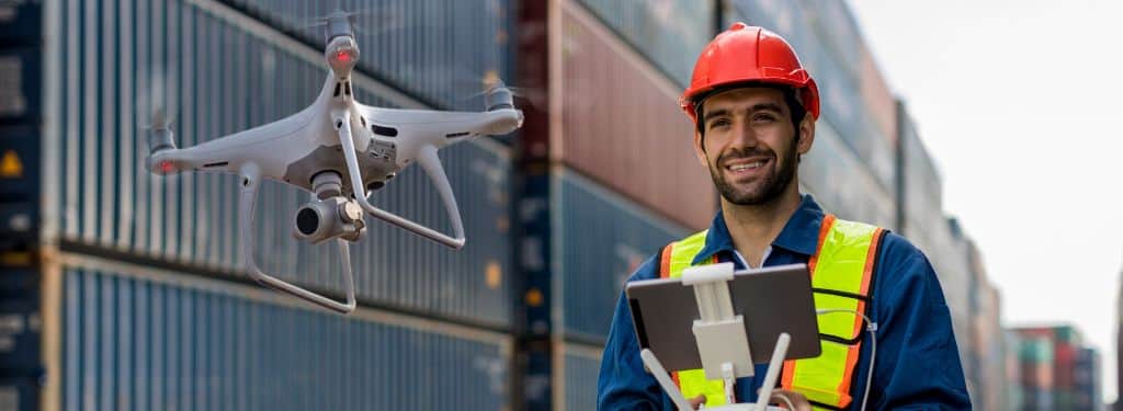 a drone operator using a drone management software on tablet to monitor drone operations