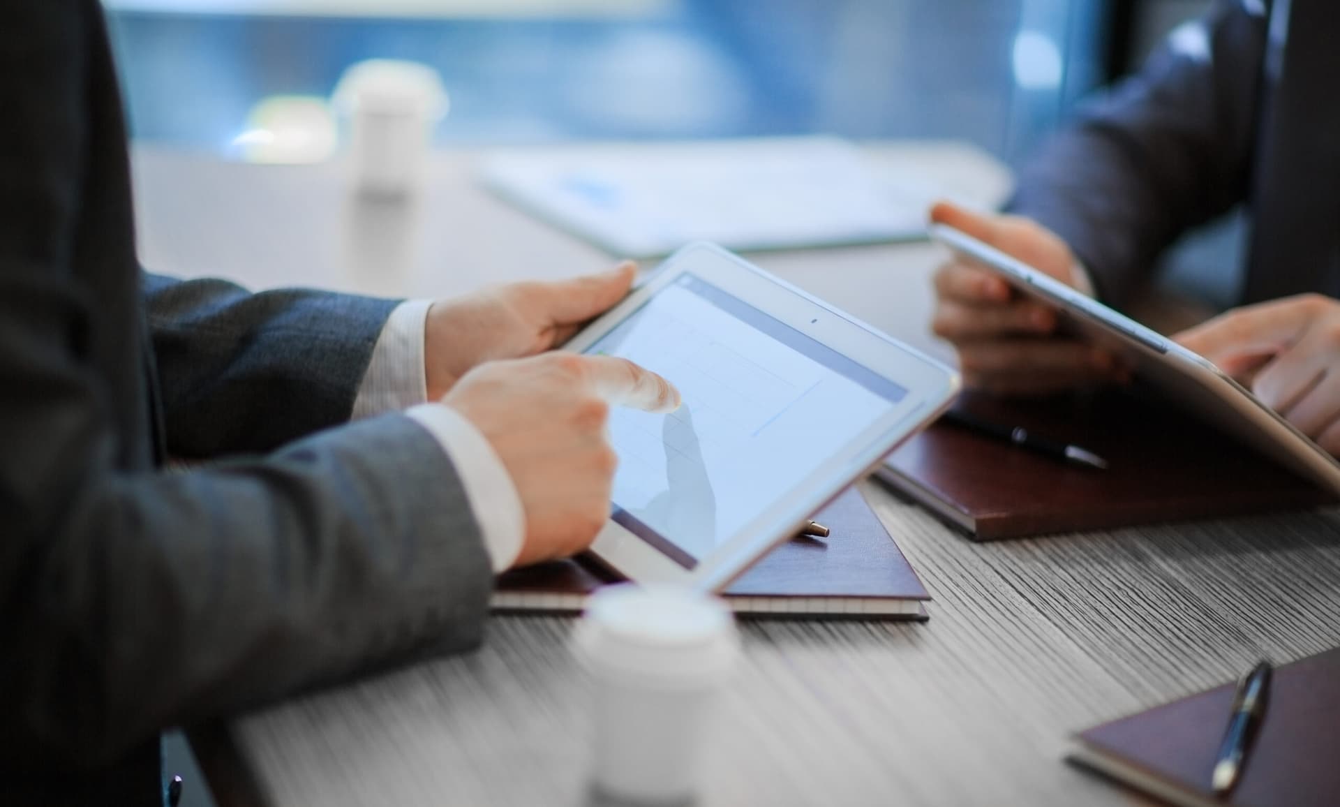 Two managers identifying vulnerability using contract risk management software