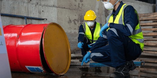 Two inspectors doing safety analysis using a hazardous waste inspection checklist