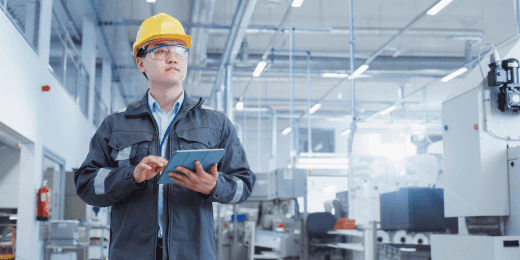 An inspector using a factory visit report template to guide his inspection