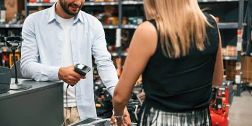 lone retail worker helping a woman make a purchase