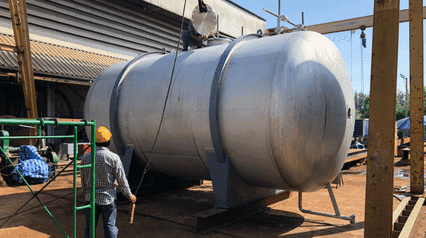 workers inspecting a steel pressure vessel
