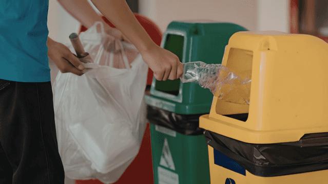 A staff member is conducting a waste storage and disposal area inspection checklist