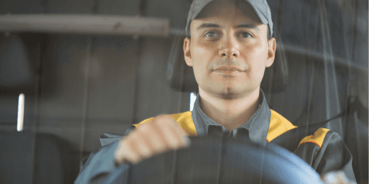 Truck driver focused while holding the steering wheel for CDL road test inspection