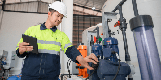 Man inspecting water system holding a tablet in hand