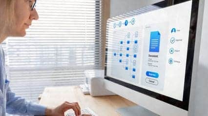 a records manager organizing records and documents using a desktop for ISO 15489 conformance