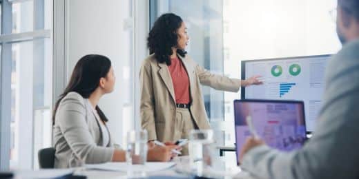 a group of executives conducting a meeting while using a GRC Capability Model to review their GRC practices