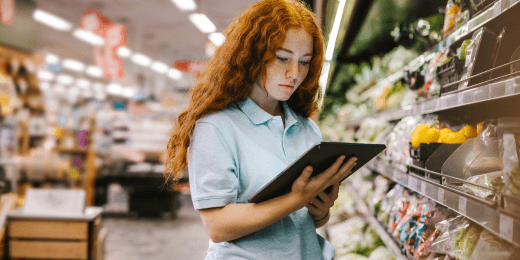 A grocery retail worker managing the food stocks with her tablet.