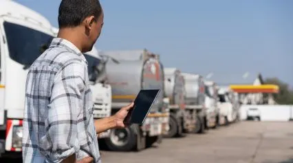 a truck driver using a vehicle pre start checklist on a tablet after conducting a pre start check|Vehicle Pre Start Checklist Sample Report|Vehicle Pre-Start Checklist