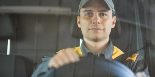 Truck driver focused while holding the steering wheel for CDL road test inspection