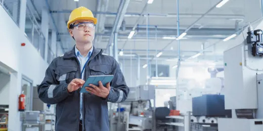 An inspector using a factory visit report template to guide his inspection