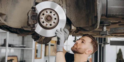 Technician inspecting a brake using a checklist